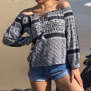 Blue and white patterned off the shoulder top in size XS/S